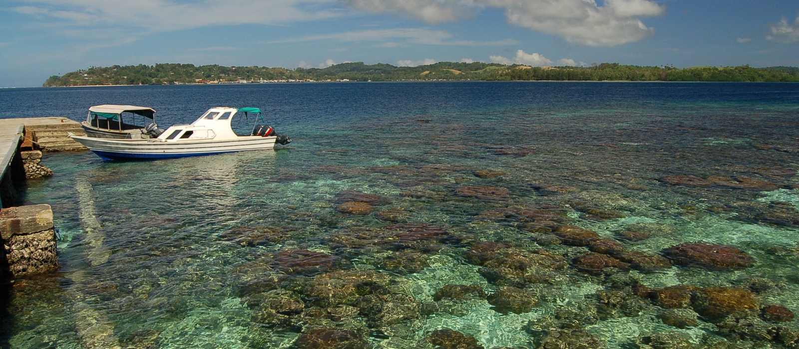 tropical coastline boat pier clear water