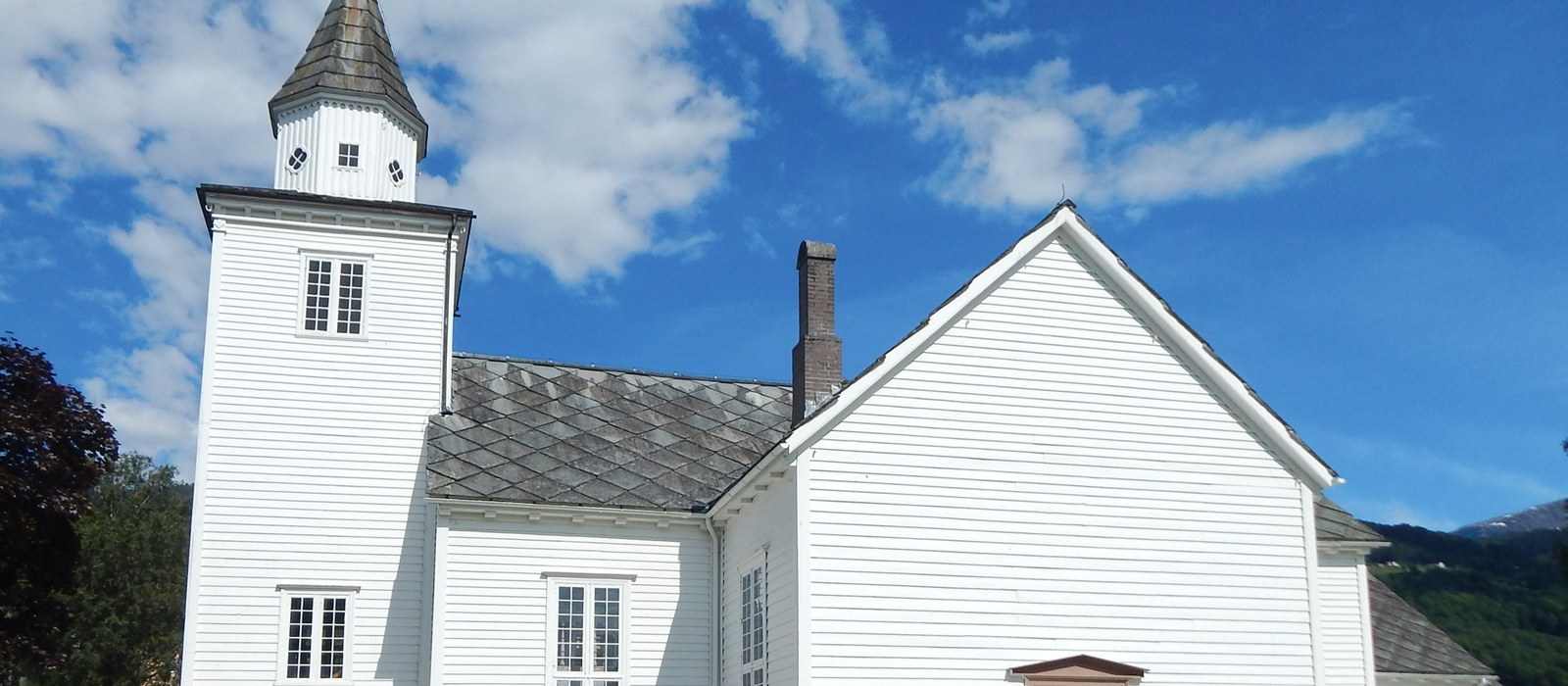 white wooden church steeple and facade