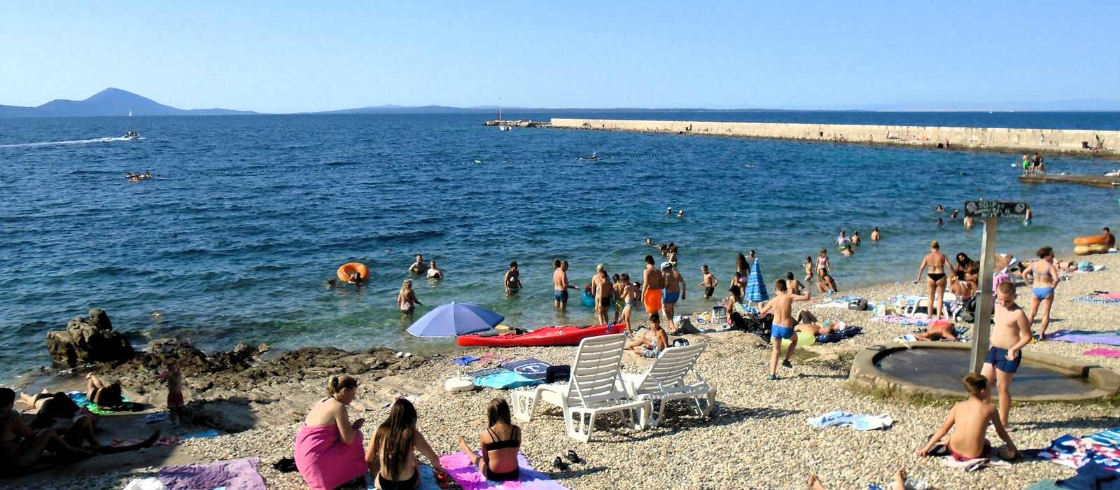 beach seaside people swimming sunbathing