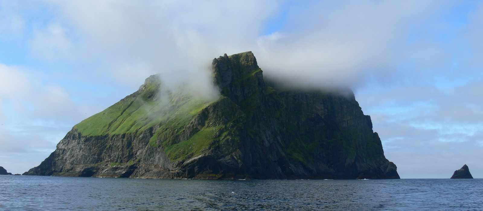 island coastline sea clouds