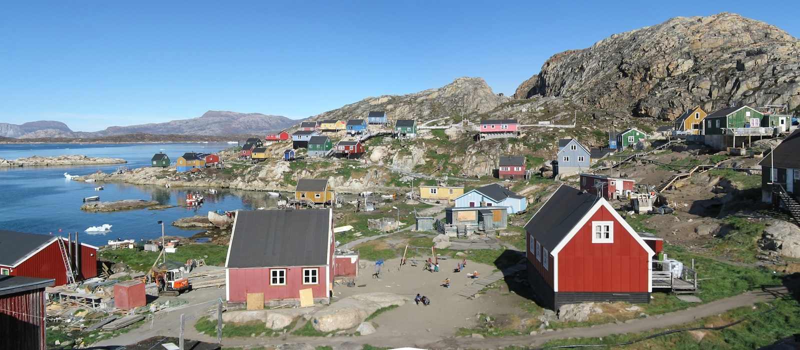 coastal village colorful houses mountains
