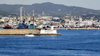 harbor lighthouse boats cityscape
