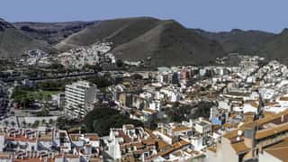 coastal town view with harbor and hills