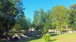 park stone bridge trees lawn