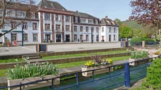 town square buildings flowers stream