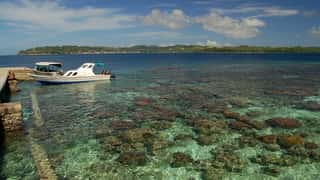 tropical coastline boat pier clear water