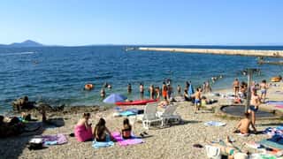 beach seaside people swimming sunbathing