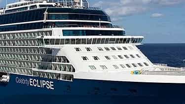 A cruise ship sails on the ocean under a blue sky - Celebrity Eclipse, Celebrity Cruises