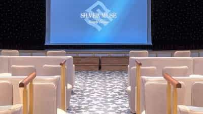 Rows of seats face a large screen in a theater - Silver Muse, Silversea Cruises