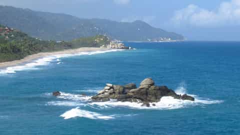 coastline beach ocean mountains