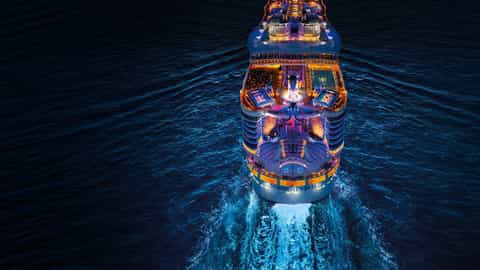 A large cruise ship sails at night - Symphony Of The Seas, Royal Caribbean