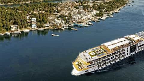 A river ship sails past a town on the bank - Viking Aton, Viking River Cruises