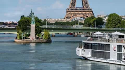 A river cruise ship sails past the Eiffel Tower and Statue of Liberty - Viking Fjorgyn, Viking River Cruises