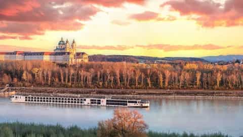 A river ship sails past a monastery at sunset - Viking Haki, Viking River Cruises
