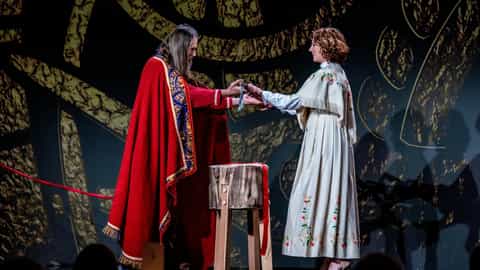 Two performers exchange an item on stage - Viking Jupiter, Viking Cruises