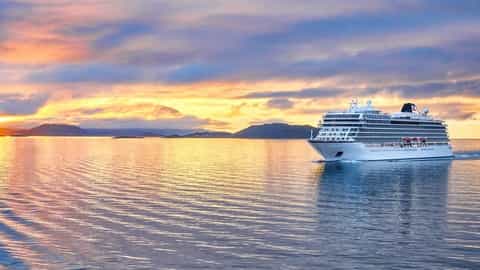 A cruise ship sails on the water at sunset - Viking Mars, Viking Cruises