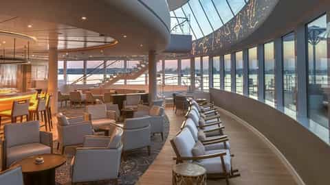 A modern bar lounge with large windows overlooking the water - Viking Mississippi, Viking River Cruises