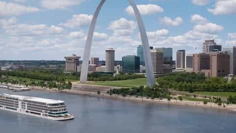 A riverboat sails past the Gateway Arch and city skyline - Viking Mississippi, Viking River Cruises
