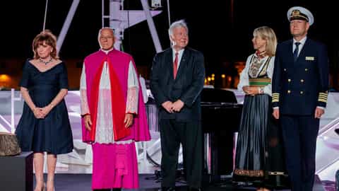 Five people stand on a deck at night - Viking Orion, Viking Cruises