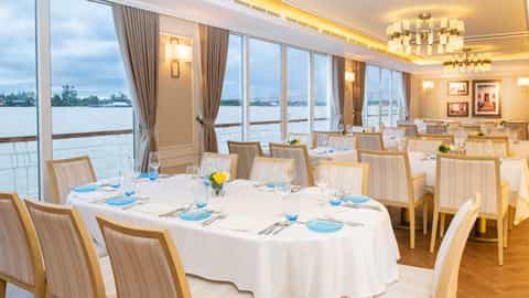 A formal dining room with tables set for a meal - Viking Saigon, Viking River Cruises