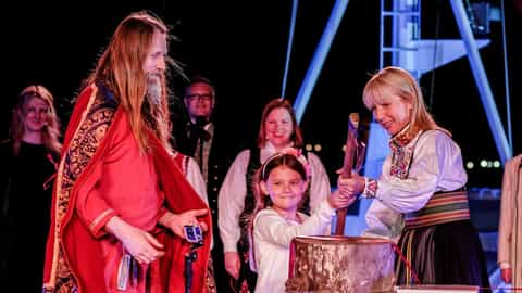 People in traditional clothing participate in a ceremony - Viking Sea, Viking Cruises