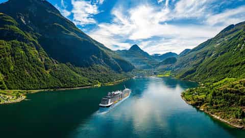 A large cruise ship sails through a Norwegian fjord - Anthem of the Seas, Royal Caribbean