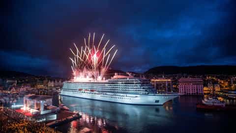 A large cruise ship is illuminated by fireworks at night - Viking Star, Viking Cruises