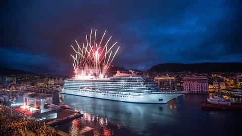 A large cruise ship is illuminated by fireworks at night - Viking Star, Viking Cruises