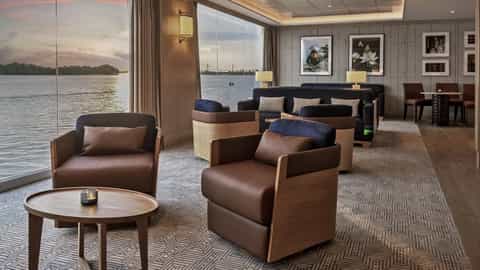 Comfortable seating in a lounge with a river view at sunset - Viking Tonle, Viking River Cruises