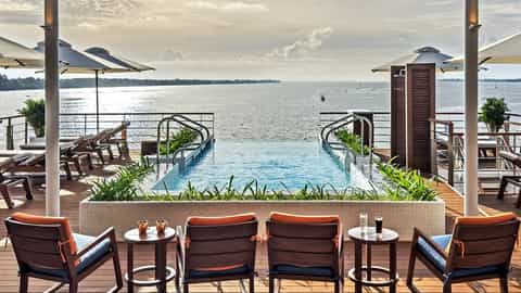 Infinity pool and lounge chairs on a wooden deck - Viking Tonle, Viking River Cruises
