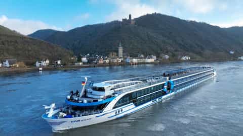A river ship cruises past a village and castle - VIVA Enjoy, Viva Cruises