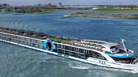 A modern river ship cruises on a wide river - VIVA Enjoy, Viva Cruises