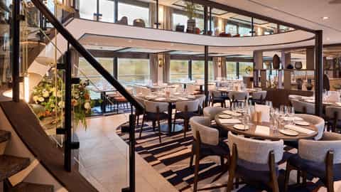 A dining room with tables set for meals - VIVA Enjoy, Viva Cruises