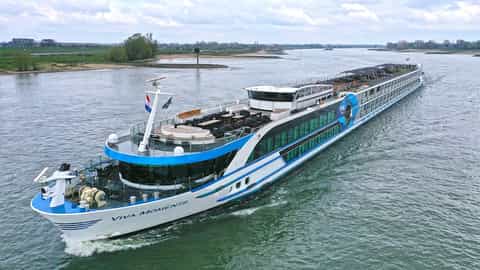 A river cruise ship sails on a waterway - VIVA Moments, Viva Cruises