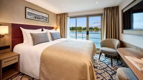 A cabin with twin beds and a view of a river - VIVA Ruby, Viva Cruises