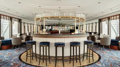 A stylish bar lounge with a central bar and seating - VIVA Voyage, Viva Cruises