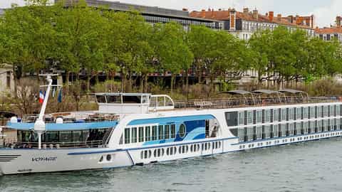 A river ship is docked next to a city embankment - VIVA Voyage, Viva Cruises
