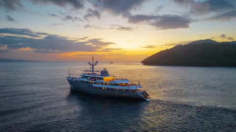 A yacht sails on the sea during sunset - Aqua Blu, Ponant Cruises