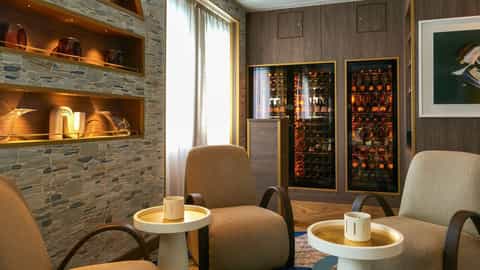 Chairs and tables in a room with wine refrigerators - Wind Surf, Windstar Cruises
