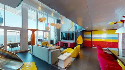 A colorful suite with a slide, large TV, and ocean view - Wonder Of The Seas, Royal Caribbean