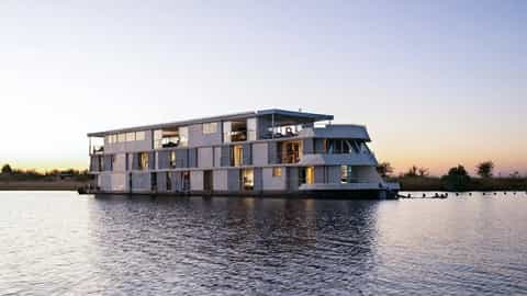 A river ship sails on calm water at sunset - Zambezi Queen, AmaWaterways