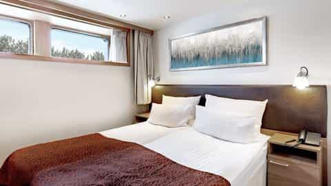 A cabin with two beds and a large artwork - Arosa Clea, A Rosa Cruises