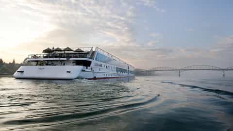 A river cruise ship sails on a misty morning - Arosa Mia, A Rosa Cruises