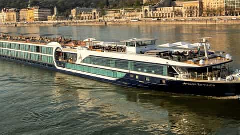 A river cruise ship sails on a wide river - Avalon Envision, Avalon Waterways