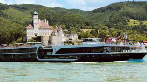 A river ship sails past a castle on a hill - Avalon Impression, Avalon Waterways