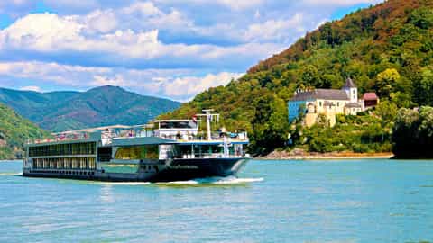 A river ship sails past a castle on a hill - Avalon Panorama, Avalon Waterways