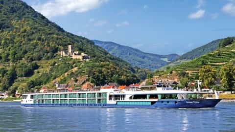 A river ship sails past a castle and vineyards - Avalon Vista, Avalon Waterways
