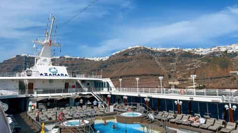 A cruise ship's pool deck with loungers and a jacuzzi - Azamara Onward, Azamara Cruises