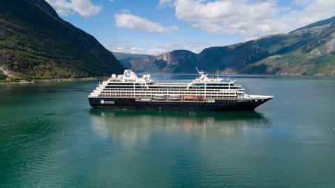 A cruise ship sails through a Norwegian fjord - Azamara Pursuit, Azamara Cruises