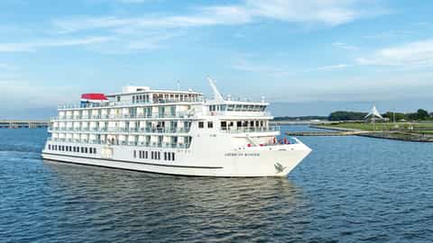 A white cruise ship sails on blue water - ACL American Ranger, American Cruise Lines
